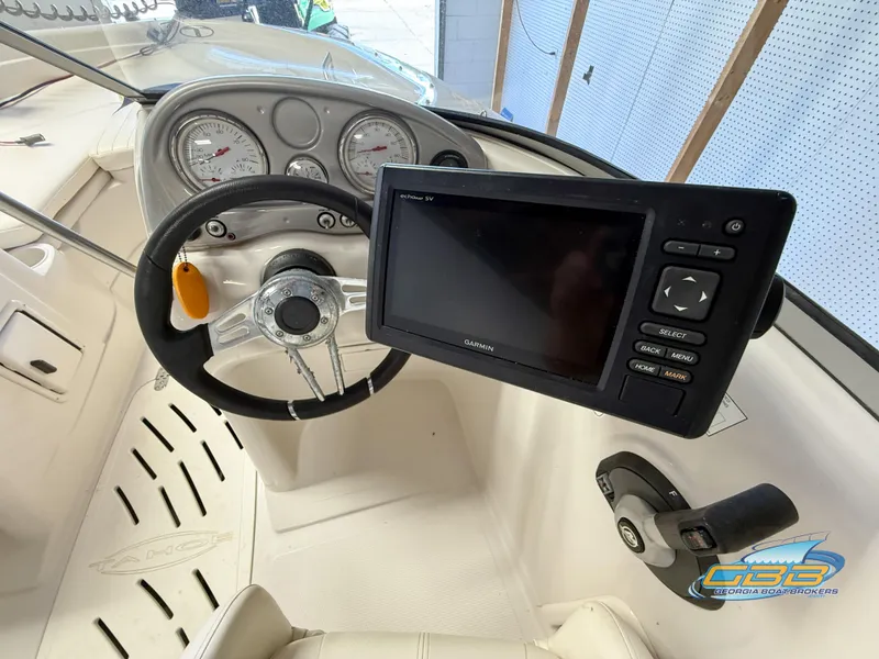 Slide: The Image of 2007 Tahoe Q7i SF boat dashboard with steering wheel and Garmin navigation system. - 16