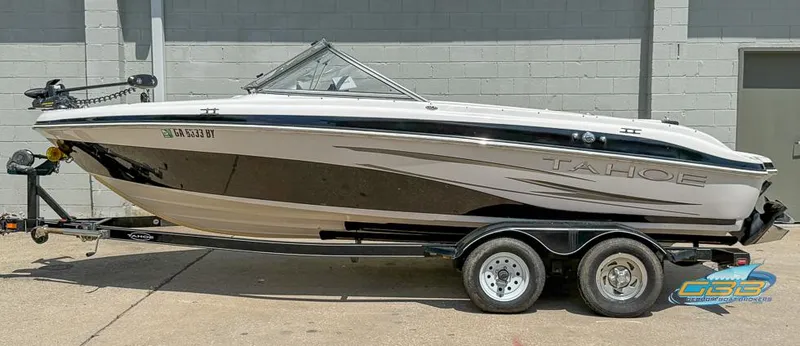 Slide: The Image of 2007 Tahoe Q7i SF boat on trailer, parked outdoors, side view. - 2