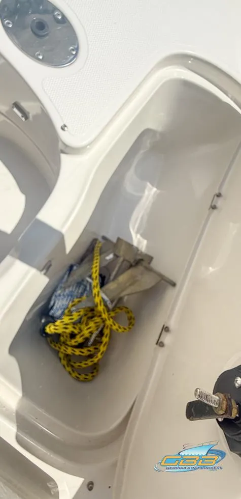 Slide: The Image of 2007 Tahoe Q7i SF boat storage compartment with anchor and yellow rope. - 29