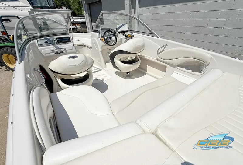 Slide: The Image of 2007 Tahoe Q7i SF boat interior with white seating and steering wheel. - 6