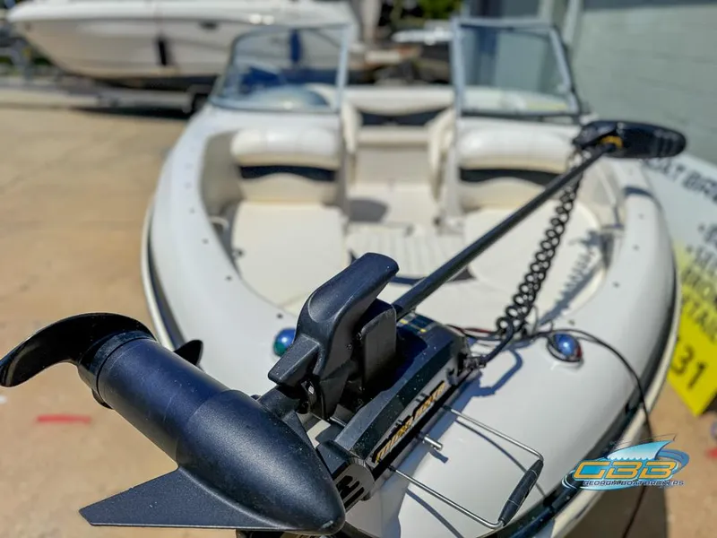 Slide: The Image of 2007 Tahoe Q7i SF boat with trolling motor, docked outdoors. - 8