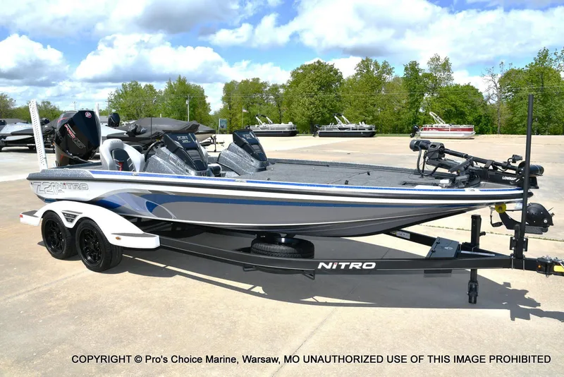 Slide: The Image of 2024 Nitro Z21 XL Pro bass boat on trailer, parked outdoors. - 1