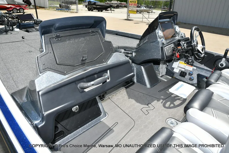 Slide: The Image of 2024 Nitro Z21 XL Pro boat interior with steering console and seating. - 14