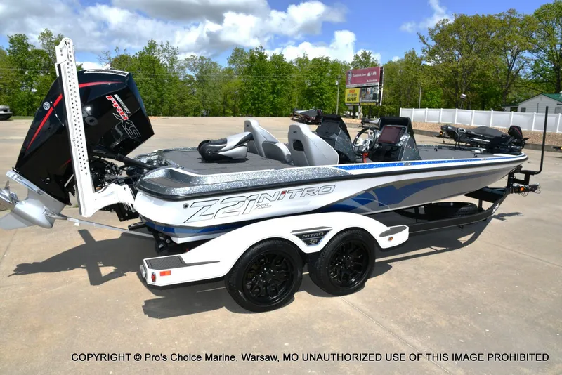 Slide: The Image of 2024 Nitro Z21 XL Pro boat with trailer, parked outdoors on a sunny day. - 19