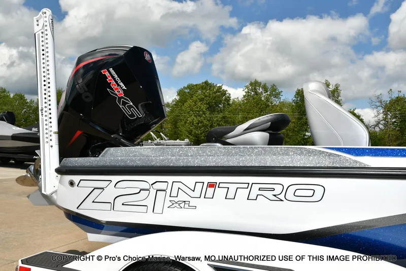 Slide: The Image of 2024 Nitro Z21 XL Pro boat with Mercury Pro XS engine, parked outdoors. - 2