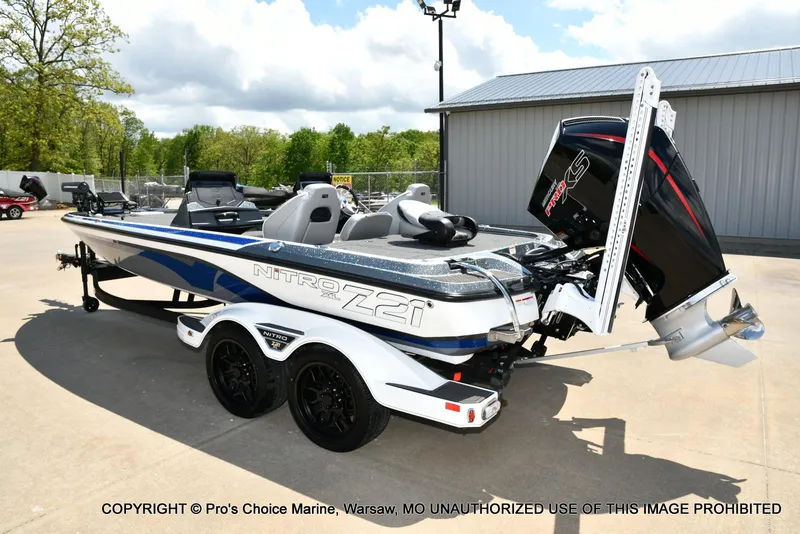 Slide: The Image of 2024 Nitro Z21 XL Pro boat with powerful engine, parked outdoors on a sunny day. - 26