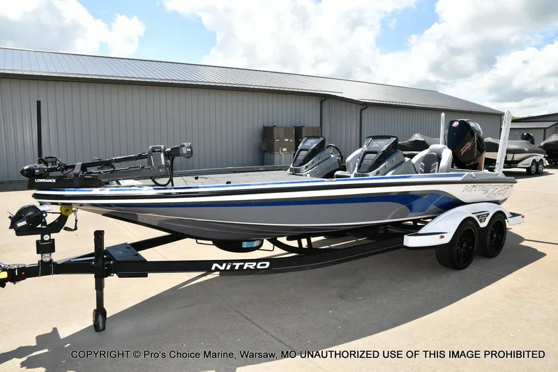 Slide: The Image of 2024 Nitro Z21 XL Pro boat on trailer, parked outdoors under a cloudy sky. - 28
