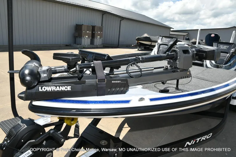 Slide: The Image of 2024 Nitro Z21 XL Pro boat with Lowrance Ghost trolling motor, parked outdoors. - 29