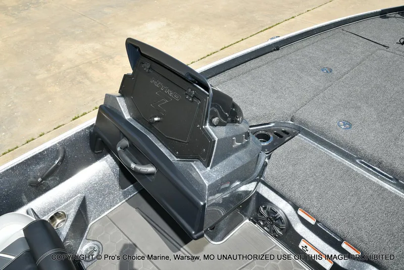 Slide: The Image of 2024 Nitro Z21 XL Pro boat interior with storage compartment and carpeted deck. - 49