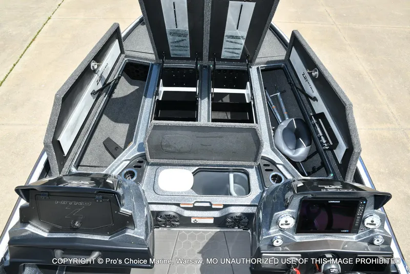 Slide: The Image of 2024 Nitro Z21 XL Pro boat interior with open storage compartments and control panels. - 9