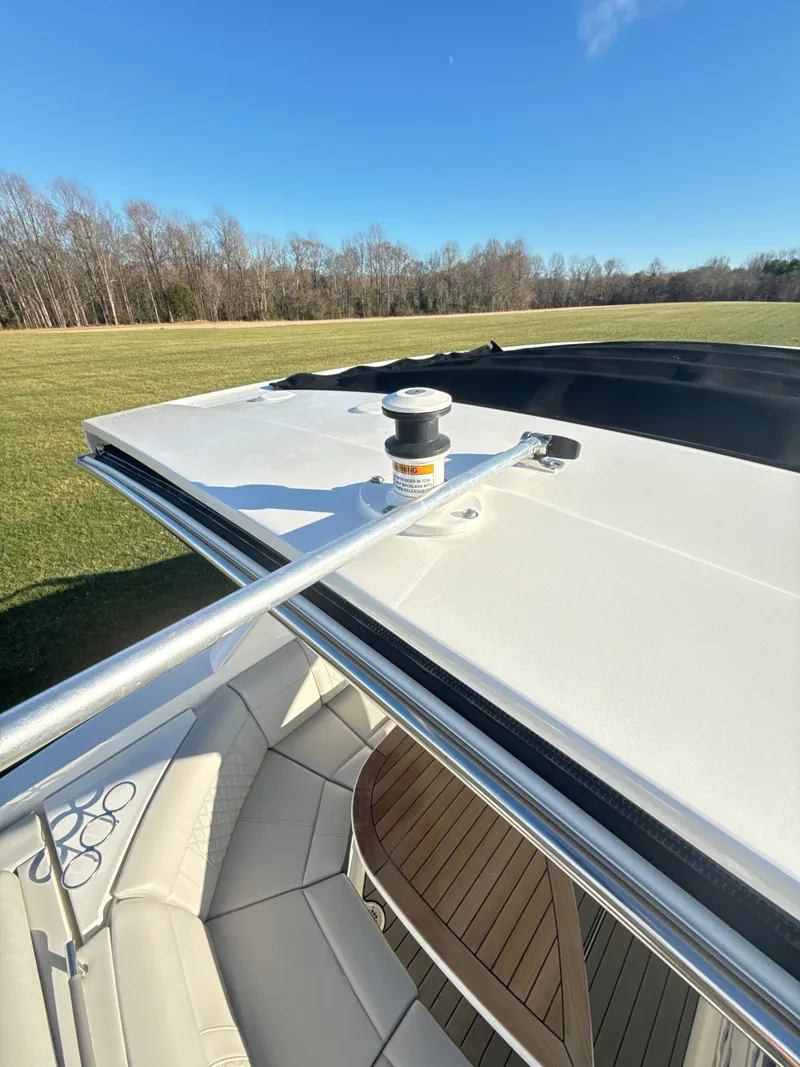 Slide: The Image of 2023 Sea Ray SLX 310 OB boat with sleek design and spacious seating. - 19