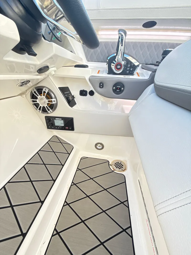 Slide: The Image of 2023 Sea Ray SLX 310 OB cockpit with modern controls and sleek design. - 21