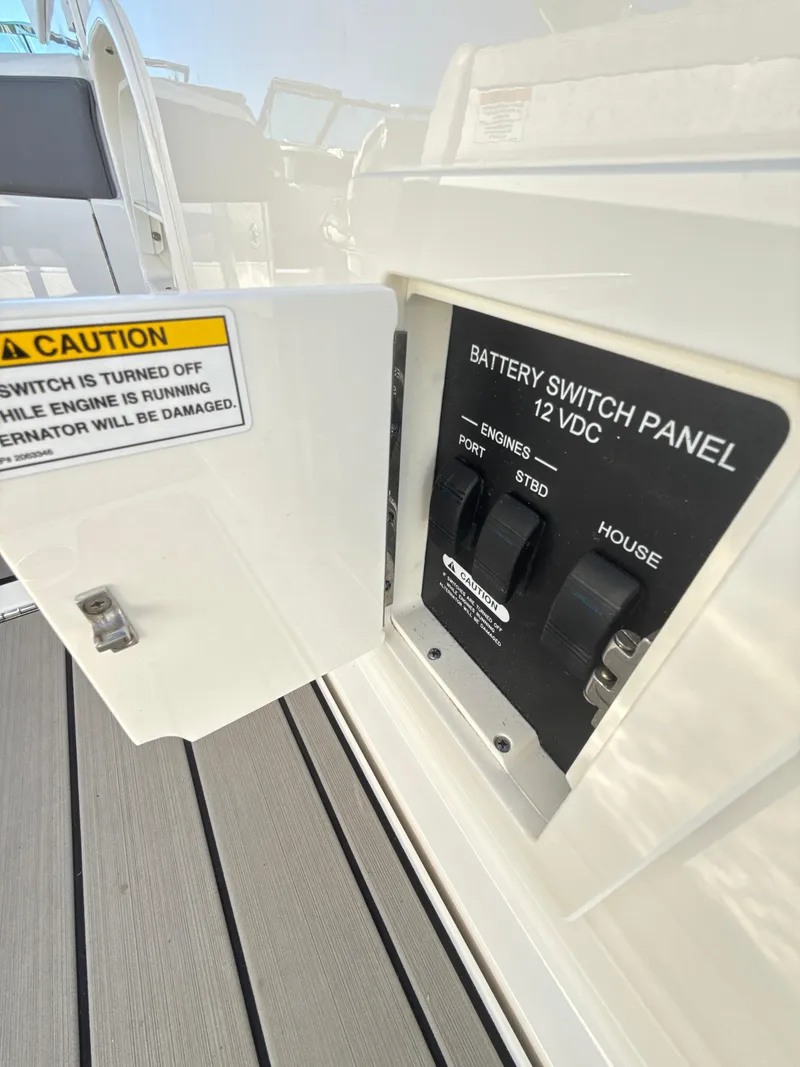 Slide: The Image of Battery switch panel on 2023 Sea Ray SLX 310 OB boat, showing engine and house controls. - 25