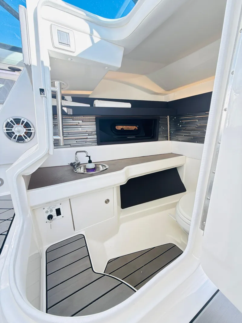 Slide: The Image of 2023 Sea Ray SLX 310 OB interior with sleek design and modern amenities. - 41