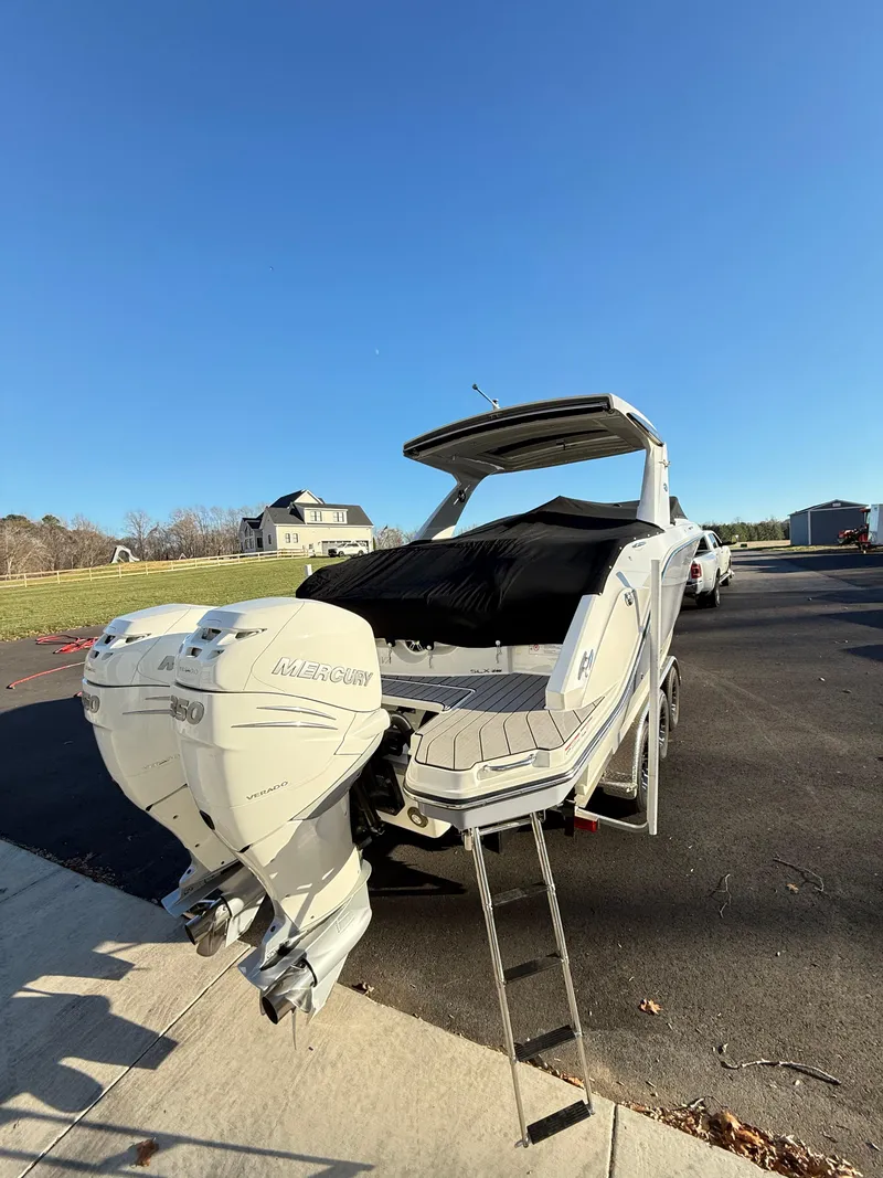 Slide: The Image of 2023 Sea Ray SLX 310 OB boat with dual Mercury outboard engines on a sunny day. - 44