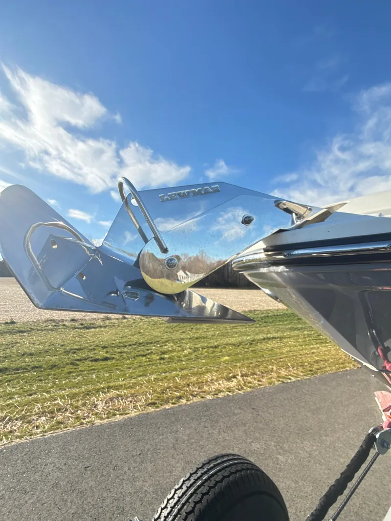 Slide: The Image of 2023 Sea Ray SLX 310 OB boat anchor detail under clear blue sky. - 45
