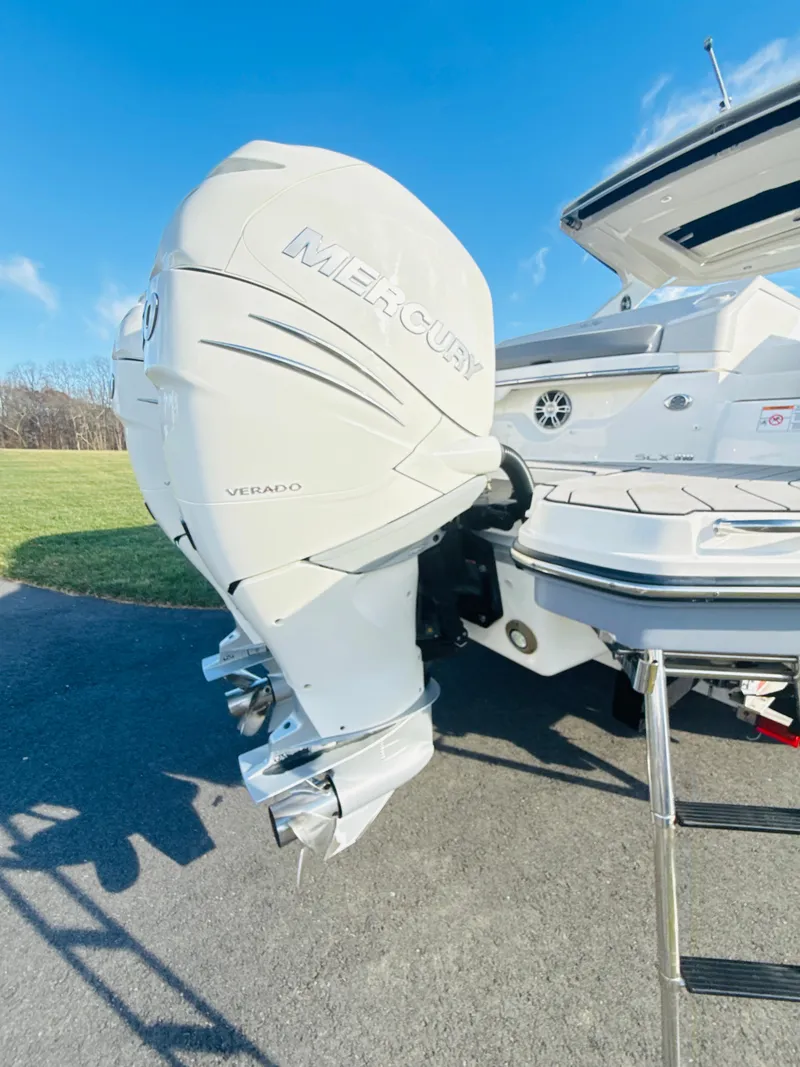 Slide: The Image of 2023 Sea Ray SLX 310 OB with Mercury Verado outboard engine, docked on a sunny day. - 7