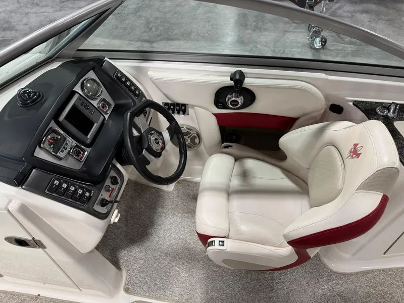 Slide: The Image of 2012 Chaparral 244 EXTREME boat interior with steering wheel and white-red seating. - 10