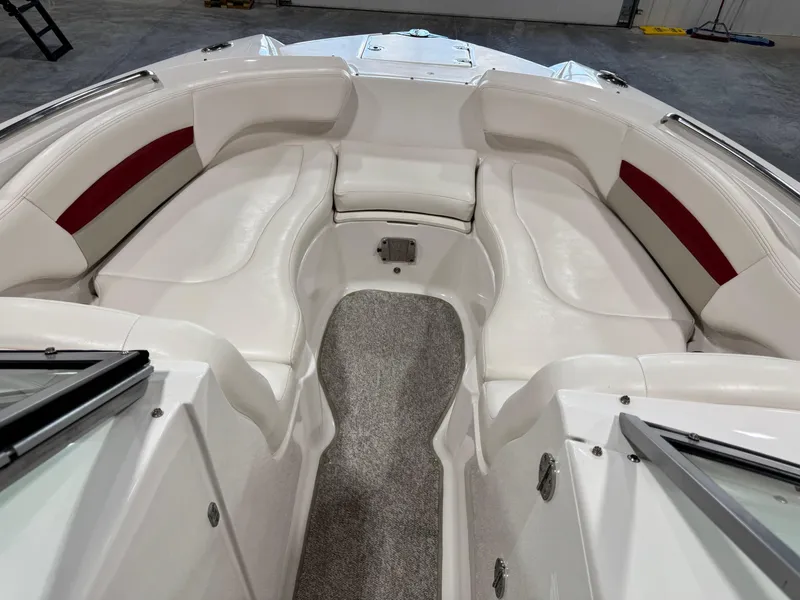 Slide: The Image of 2012 Chaparral 244 EXTREME boat interior with white seating and red accents. - 11