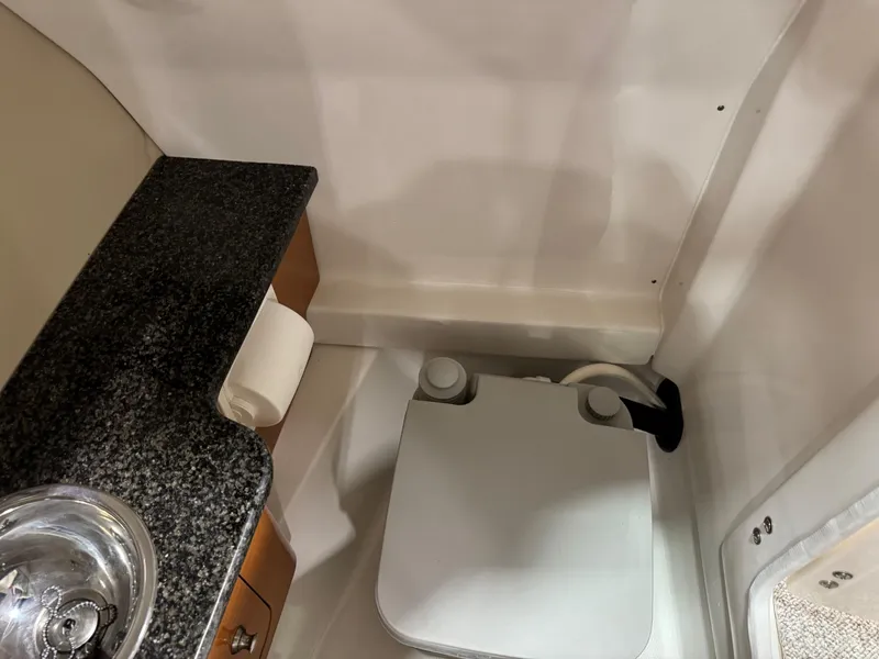 Slide: The Image of 2012 Chaparral 244 EXTREME boat interior with compact bathroom and sink. - 9