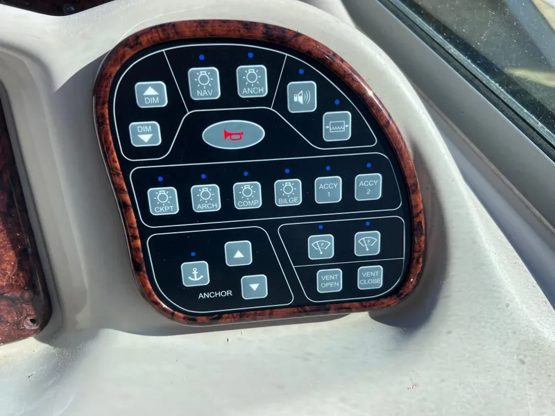 Slide: The Image of Control panel of a 2004 Sea Ray 320 Sundancer boat with various function buttons. - 10