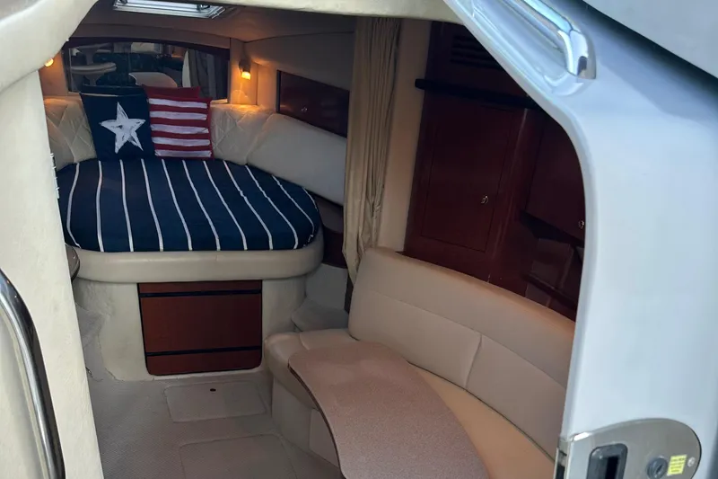 Slide: The Image of Interior of 2004 Sea Ray 320 Sundancer with cozy seating and nautical decor. - 14