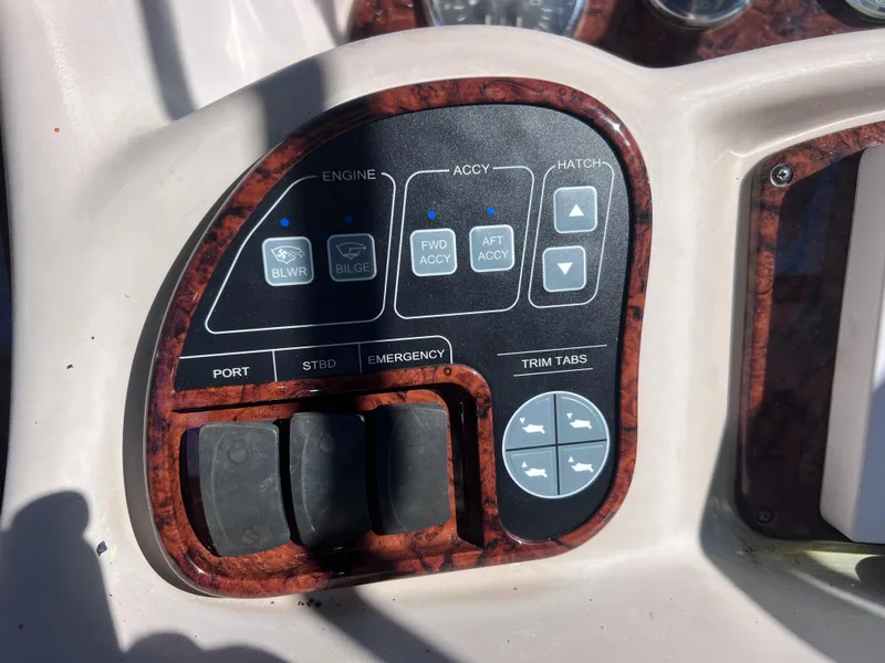 Slide: The Image of Control panel of a 2004 Sea Ray 320 Sundancer boat with various switches and buttons. - 9