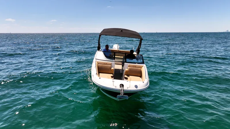 Slide: The Image of 2021 Sea Ray SDX 270 boat on open water under clear blue sky. - 11
