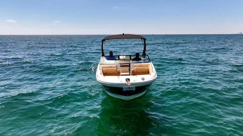 Slide: The Image of 2021 Sea Ray SDX 270 boat on open water under clear blue sky. - 12