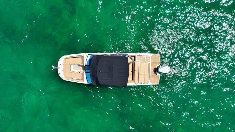 Slide: The Image of Aerial view of 2021 Sea Ray SDX 270 boat on clear green water. - 15