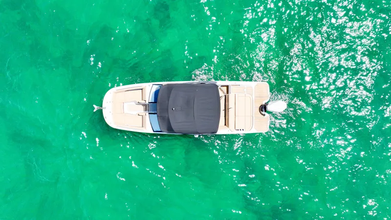 Slide: The Image of Overhead view of 2021 Sea Ray SDX 270 boat on vibrant turquoise water. - 16