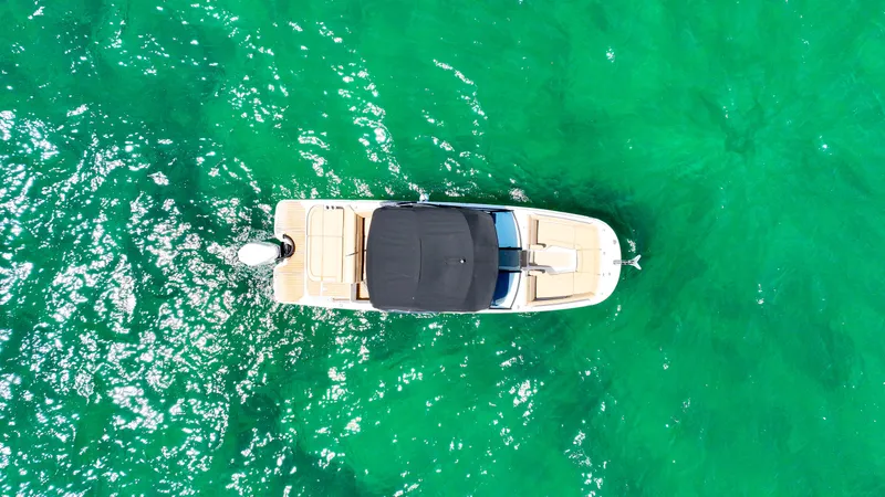 Slide: The Image of Aerial view of 2021 Sea Ray SDX 270 boat on vibrant turquoise water. - 18
