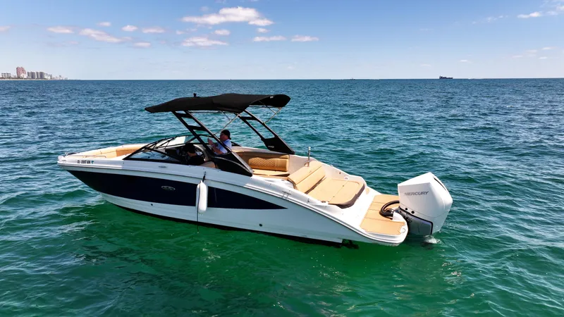 Slide: The Image of 2021 Sea Ray SDX 270 boat cruising on clear blue ocean waters. - 2