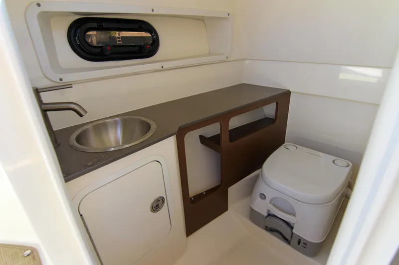 Slide: The Image of 2021 Sea Ray SDX 270 boat bathroom with sink, toilet, and storage. - 28
