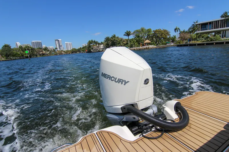 Slide: The Image of 2021 Sea Ray SDX 270 with Mercury outboard engine cruising on a scenic waterway. - 31