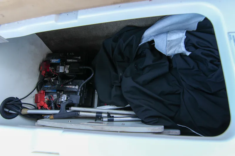 Slide: The Image of Storage compartment of 2021 Sea Ray SDX 270 with batteries and equipment. - 34