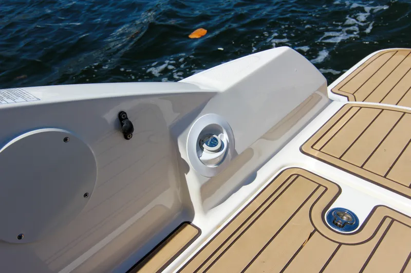 Slide: The Image of 2021 Sea Ray SDX 270 boat deck with teak flooring, near water. - 37
