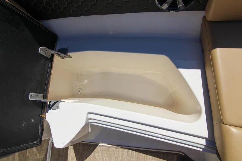 Slide: The Image of 2021 Sea Ray SDX 270 boat storage compartment with beige interior and cushioned seating. - 41