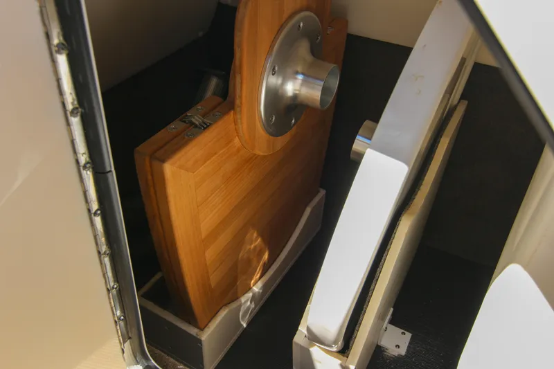 Slide: The Image of Storage compartment in a 2021 Sea Ray SDX 270 boat, featuring a wooden table. - 46
