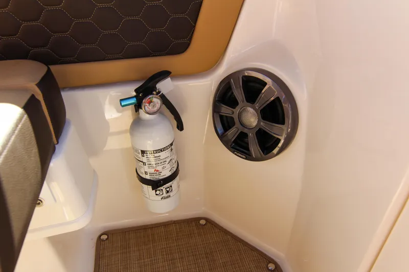 Slide: The Image of 2021 Sea Ray SDX 270 interior with fire extinguisher and speaker detail. - 49