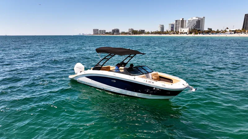 Slide: The Image of 2021 Sea Ray SDX 270 boat on ocean near city skyline. - 5