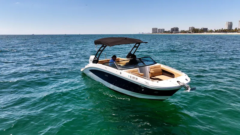 Slide: The Image of 2021 Sea Ray SDX 270 boat cruising on open water under clear skies. - 6