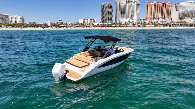 Slide: The Image of 2021 Sea Ray SDX 270 boat on ocean with city skyline in background. - 7