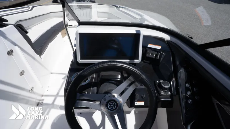 Slide: The Image of 2021 Yamaha Boats 252SE dashboard with steering wheel and touchscreen display at Long Lake Marina. - 20