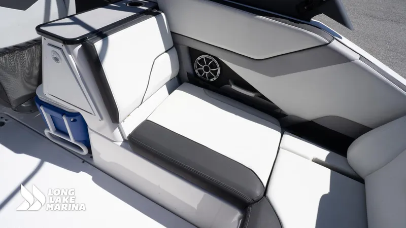 Slide: The Image of 2021 Yamaha Boats 252SE interior seating with storage and speaker, Long Lake Marina branding. - 24