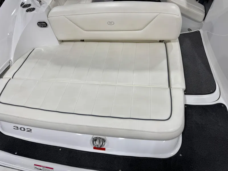 Slide: The Image of 2007 Cobalt 302 BR boat with white cushioned seating and sleek design. - 12