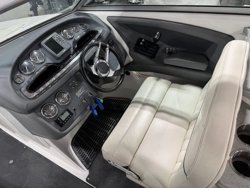 Slide: The Image of 2007 Cobalt 302 BR boat cockpit with steering wheel, gauges, and white seating. - 17