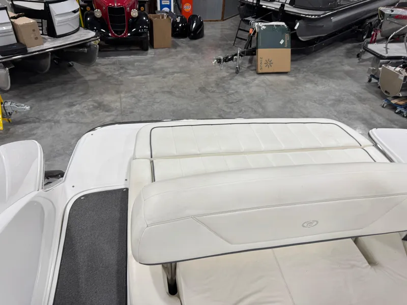 Slide: The Image of 2007 Cobalt 302 BR boat interior with white seating in a showroom. - 18