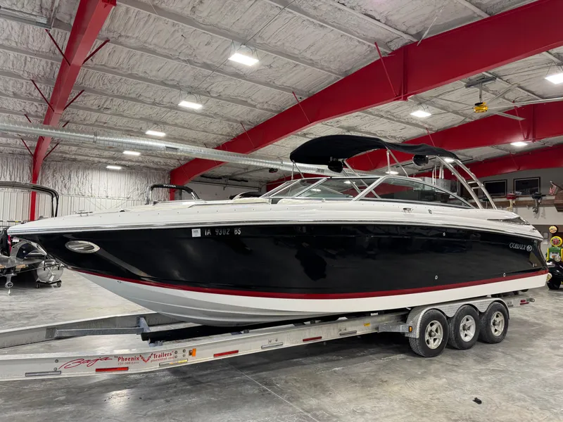Slide: The Image of 2007 Cobalt 302 BR boat on a trailer in a spacious indoor facility. - 3