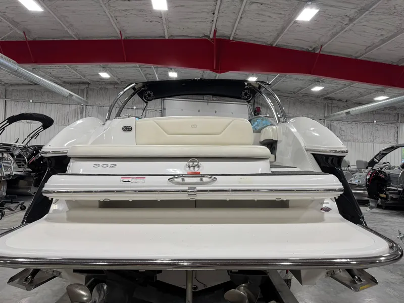 Slide: The Image of 2007 Cobalt 302 BR boat in a warehouse, rear view with swim platform. - 7
